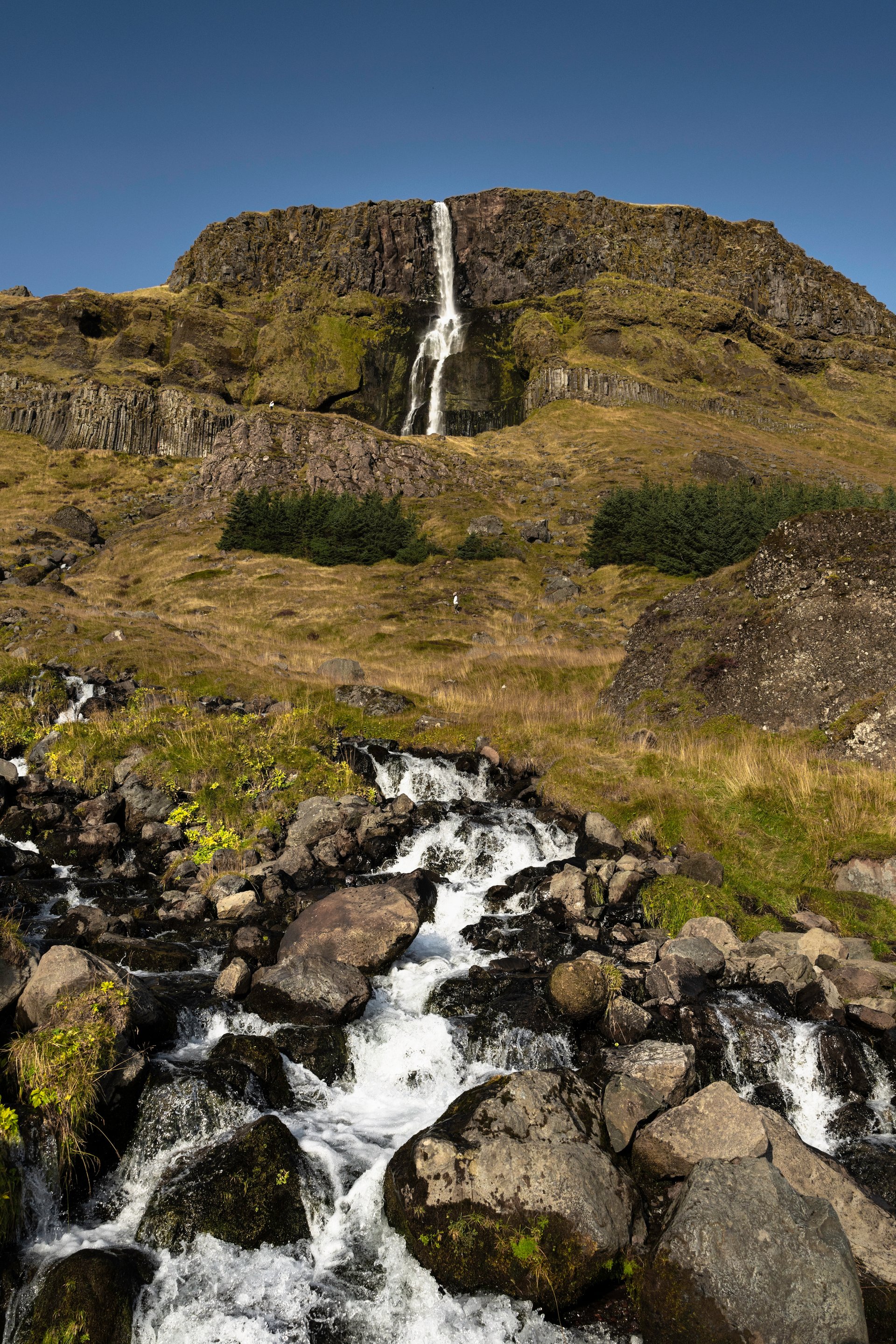 Bjarnafoss cascading down dark basalt cliffs on Snæfellsnes Peninsula
