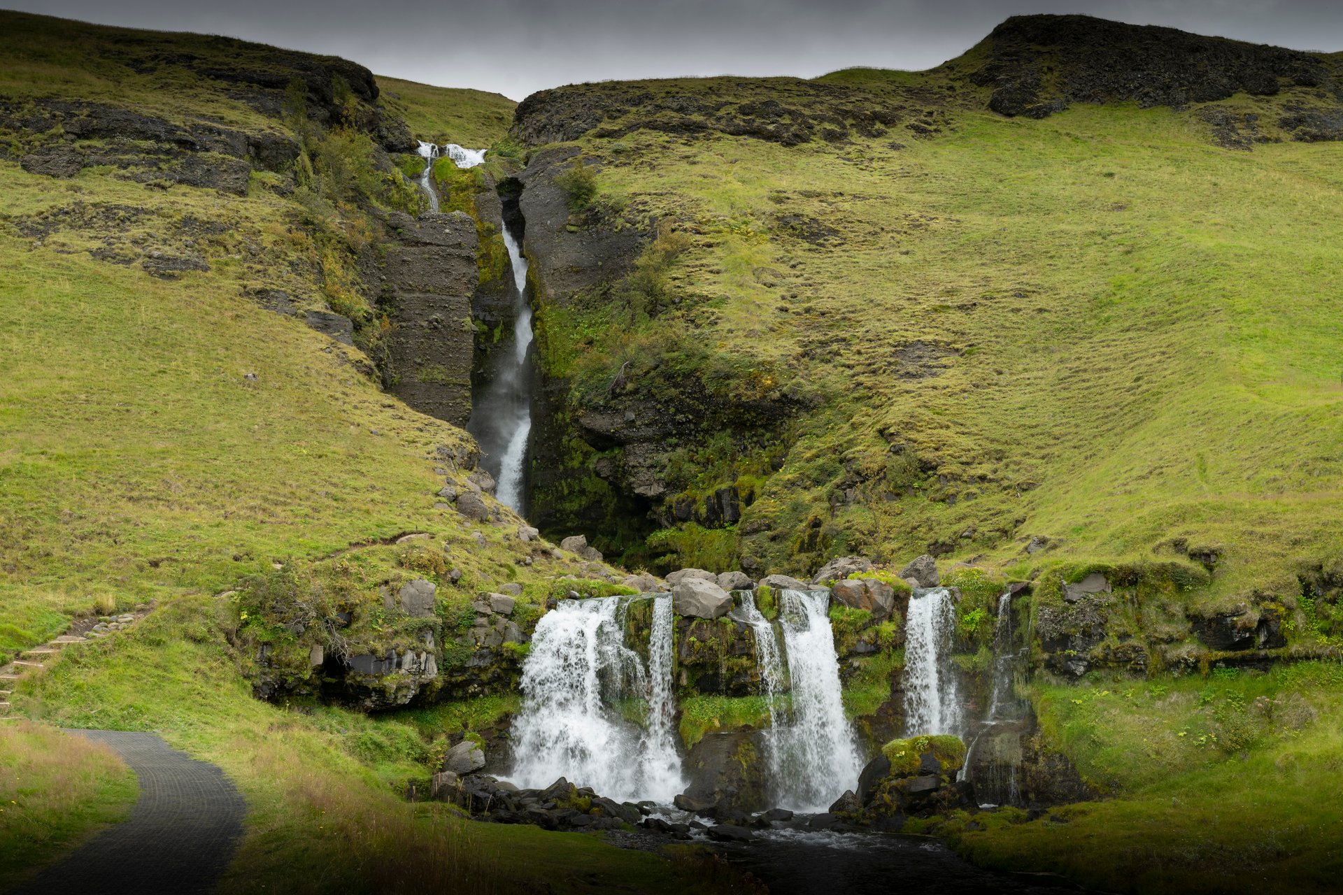Gluggafoss Window Falls with water cascading through rock openings