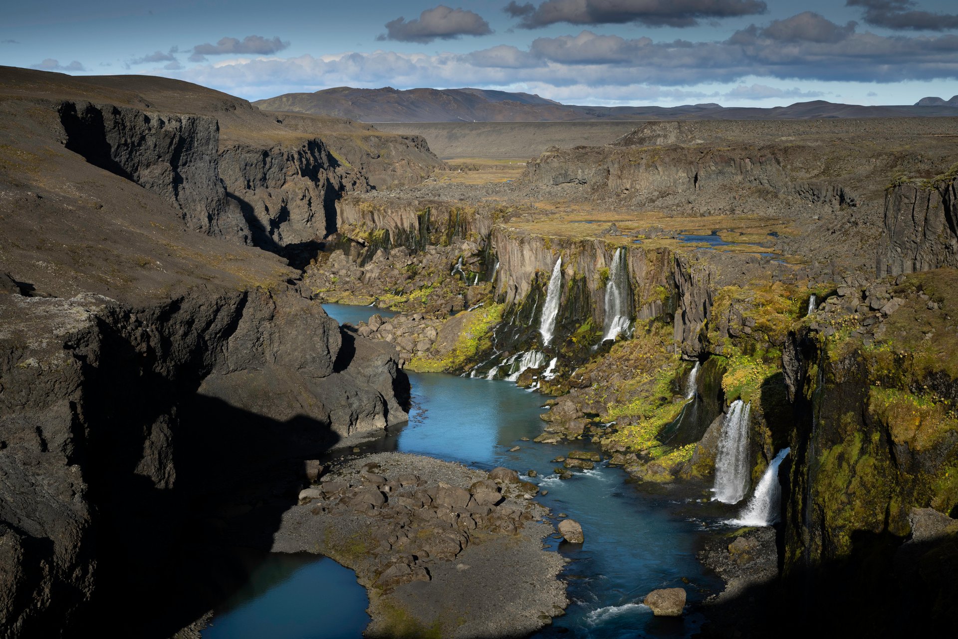 Turquoise river below the moss-covered canyon of Sigöldugljúfur