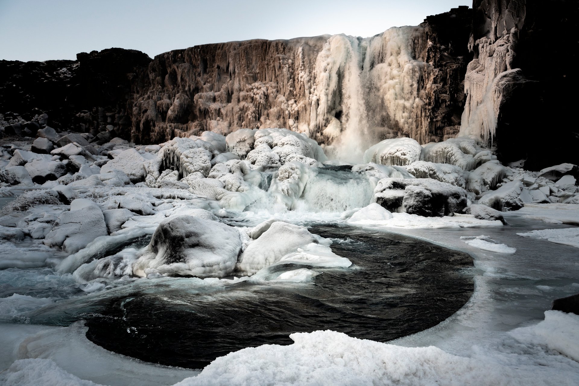 Öxarárfoss framed by tectonic plate walls in winter
