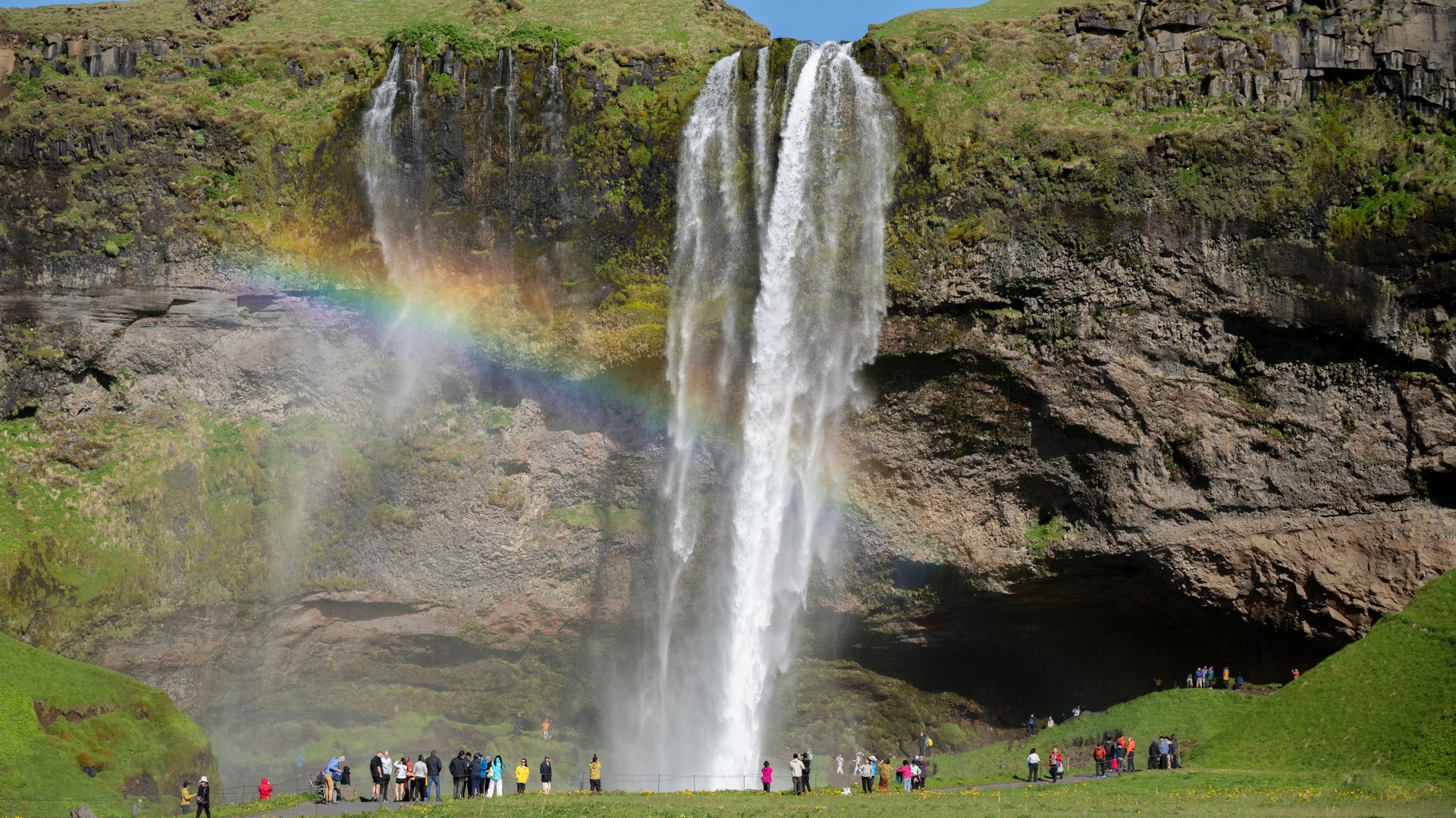 Seljalandsfoss waterfall lit by golden evening light in June