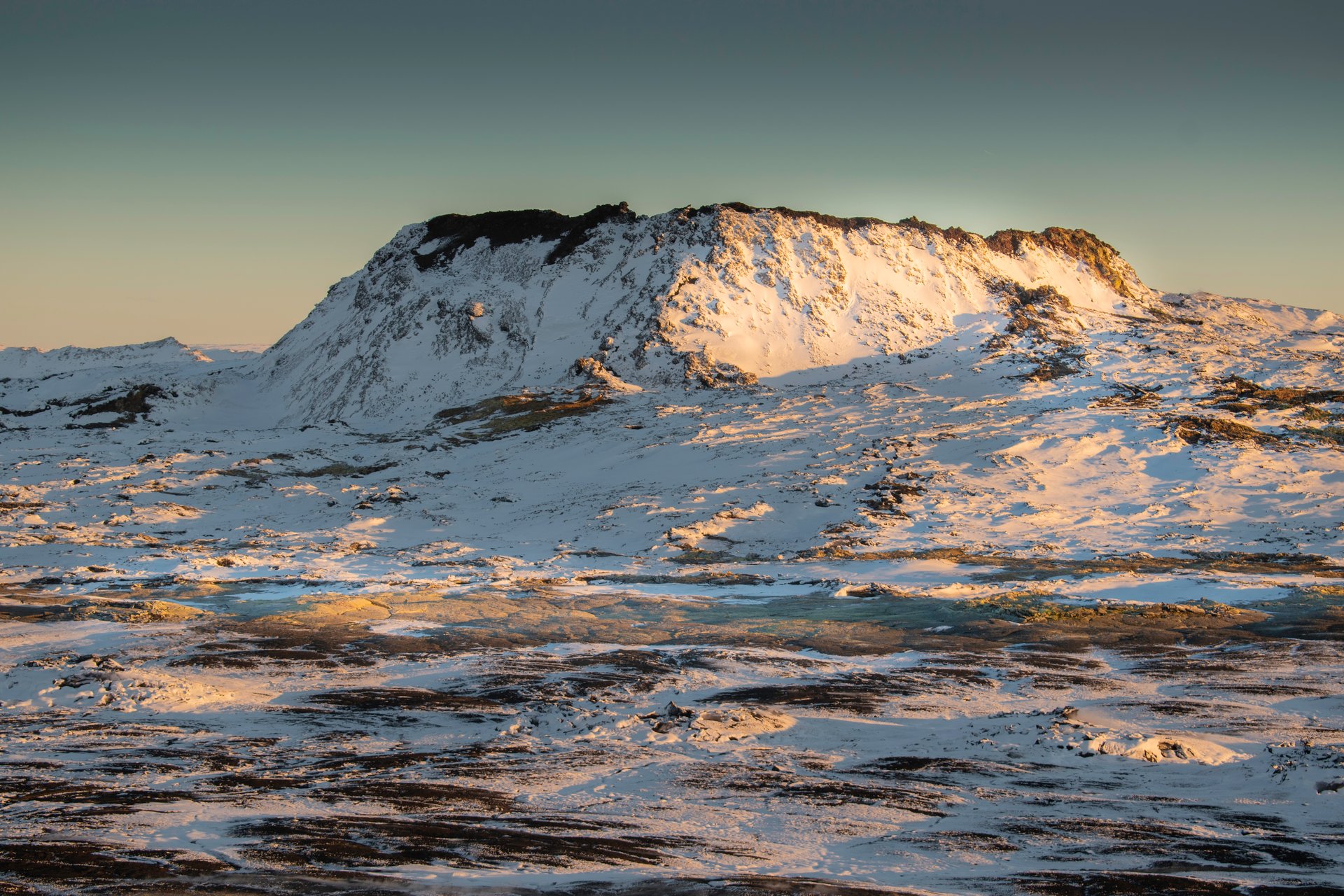 Hikers on a trail overlooking the vast Fagradalsfjall lava fields on the Reykjanes Peninsula