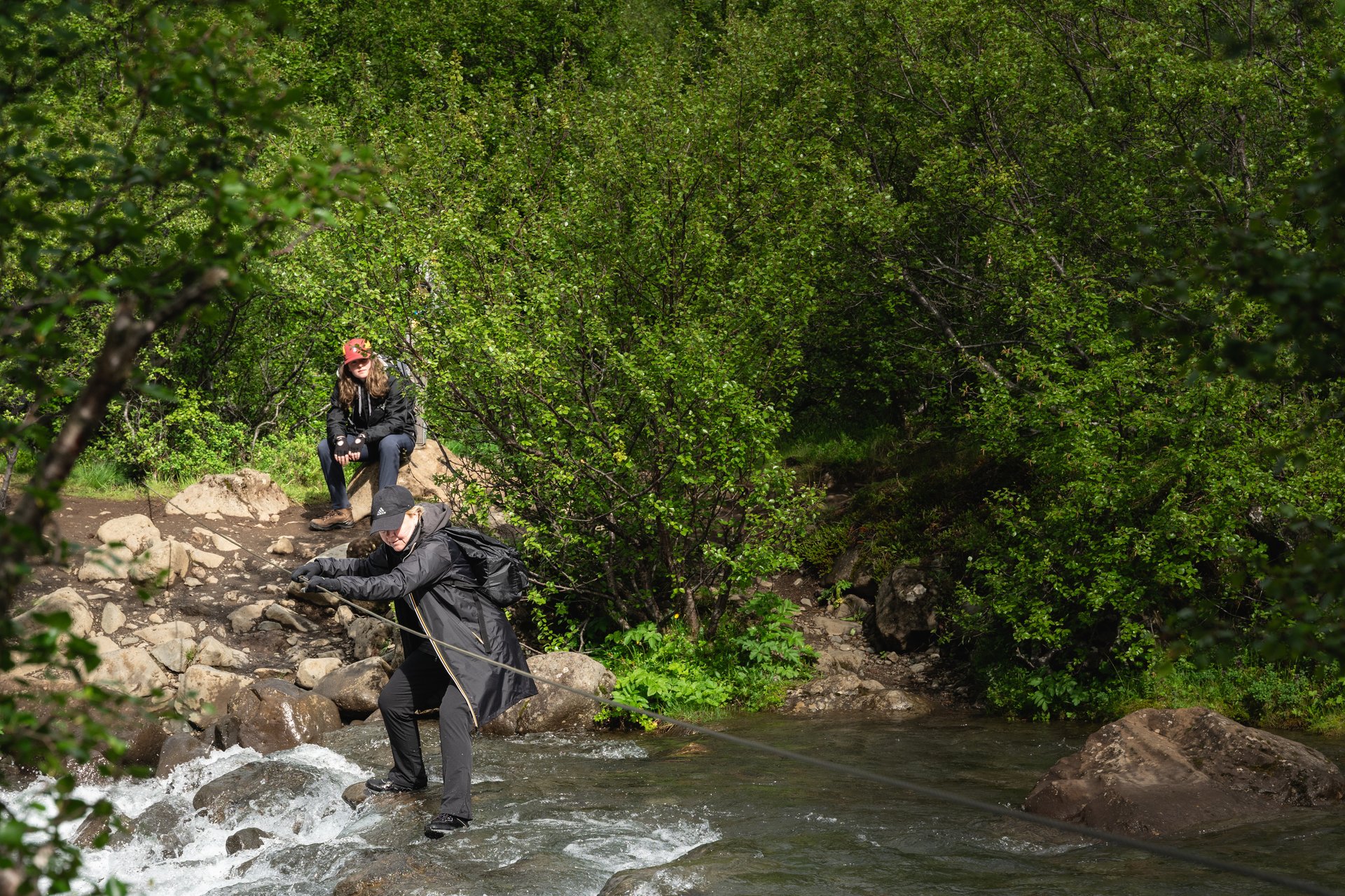 River crossing Glymur hike adventure cold water wade