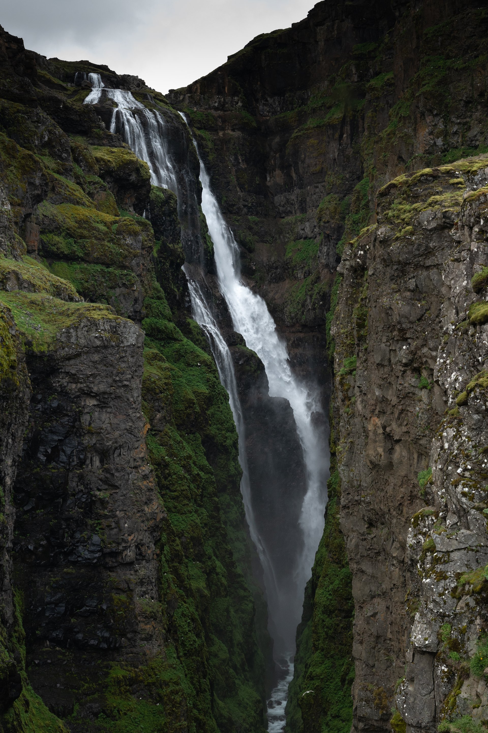 Glymur waterfall plunging into Hvalfjörður fjord from a dramatic viewpoint