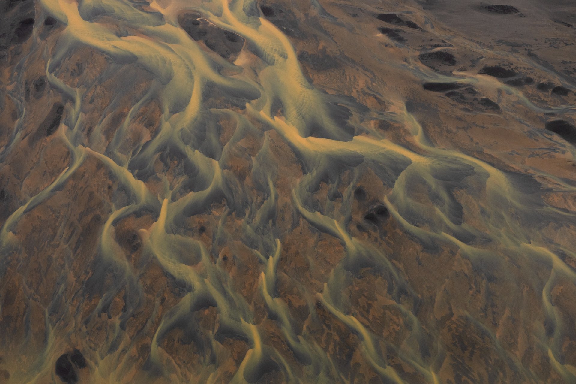 Helicopter flying over Iceland's colourful highland mountains