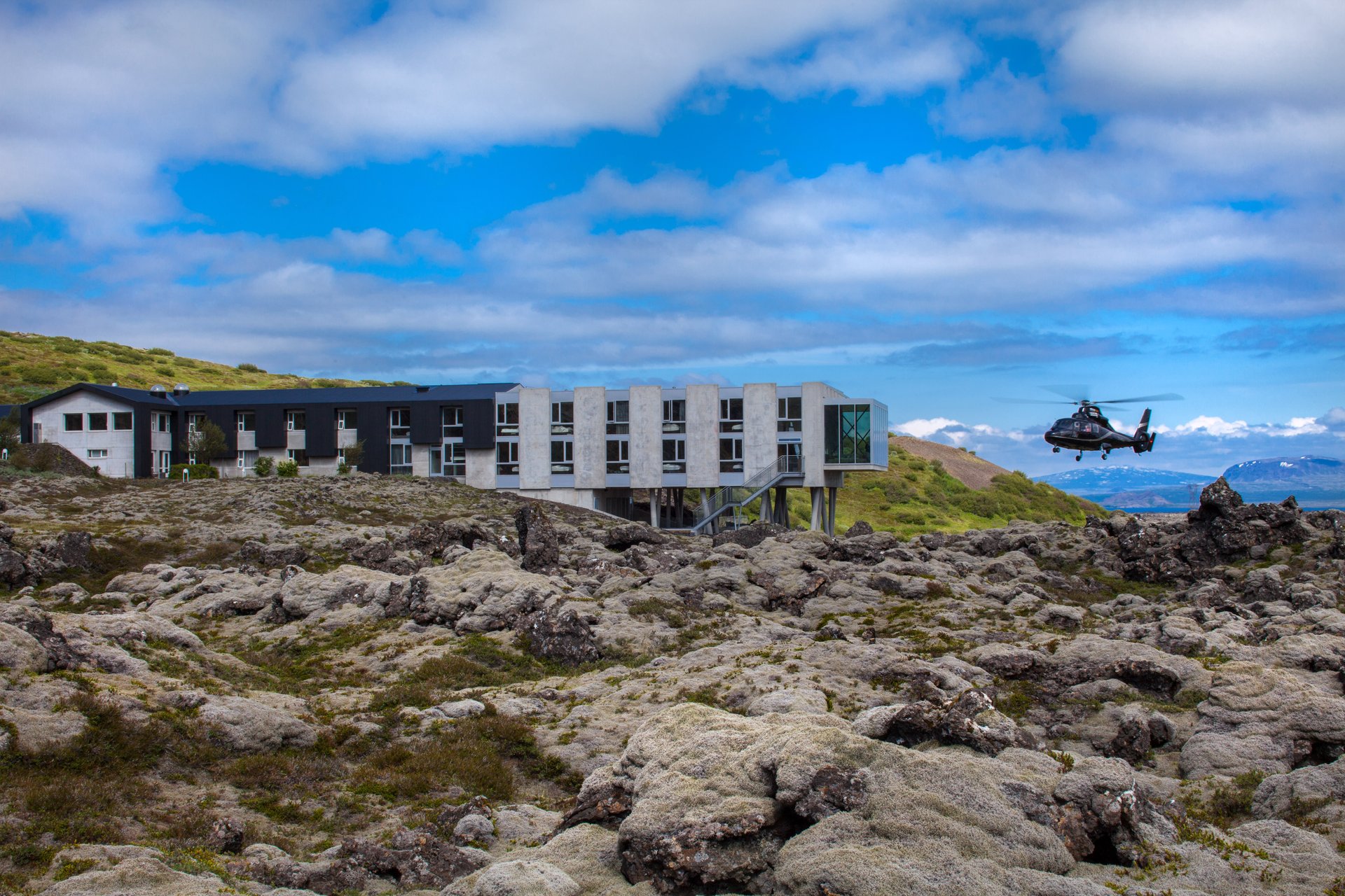 ION Adventure Hotel exterior with lava field and mountain backdrop