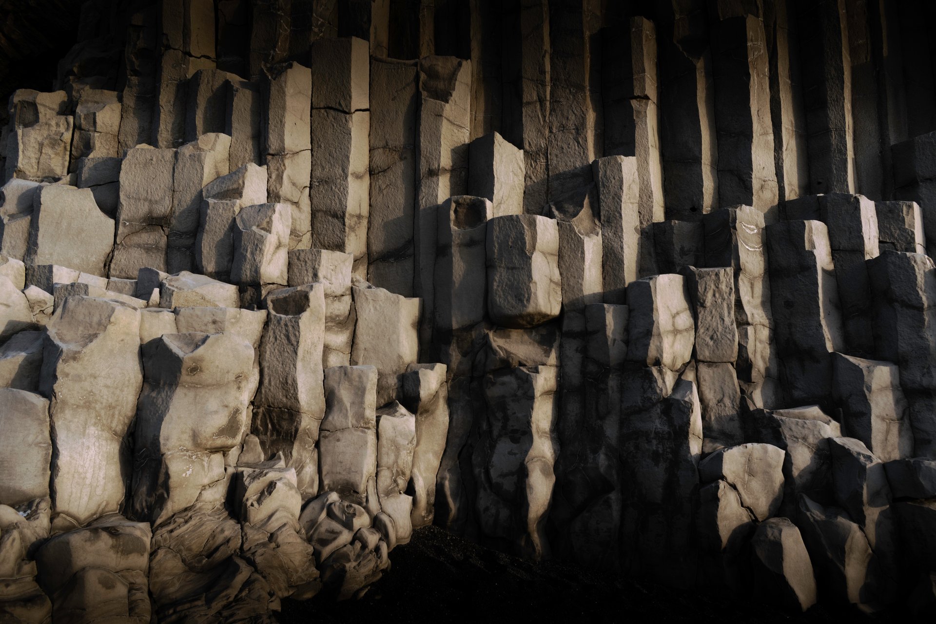Reynisfjara black sand beach with basalt sea stacks and crashing waves