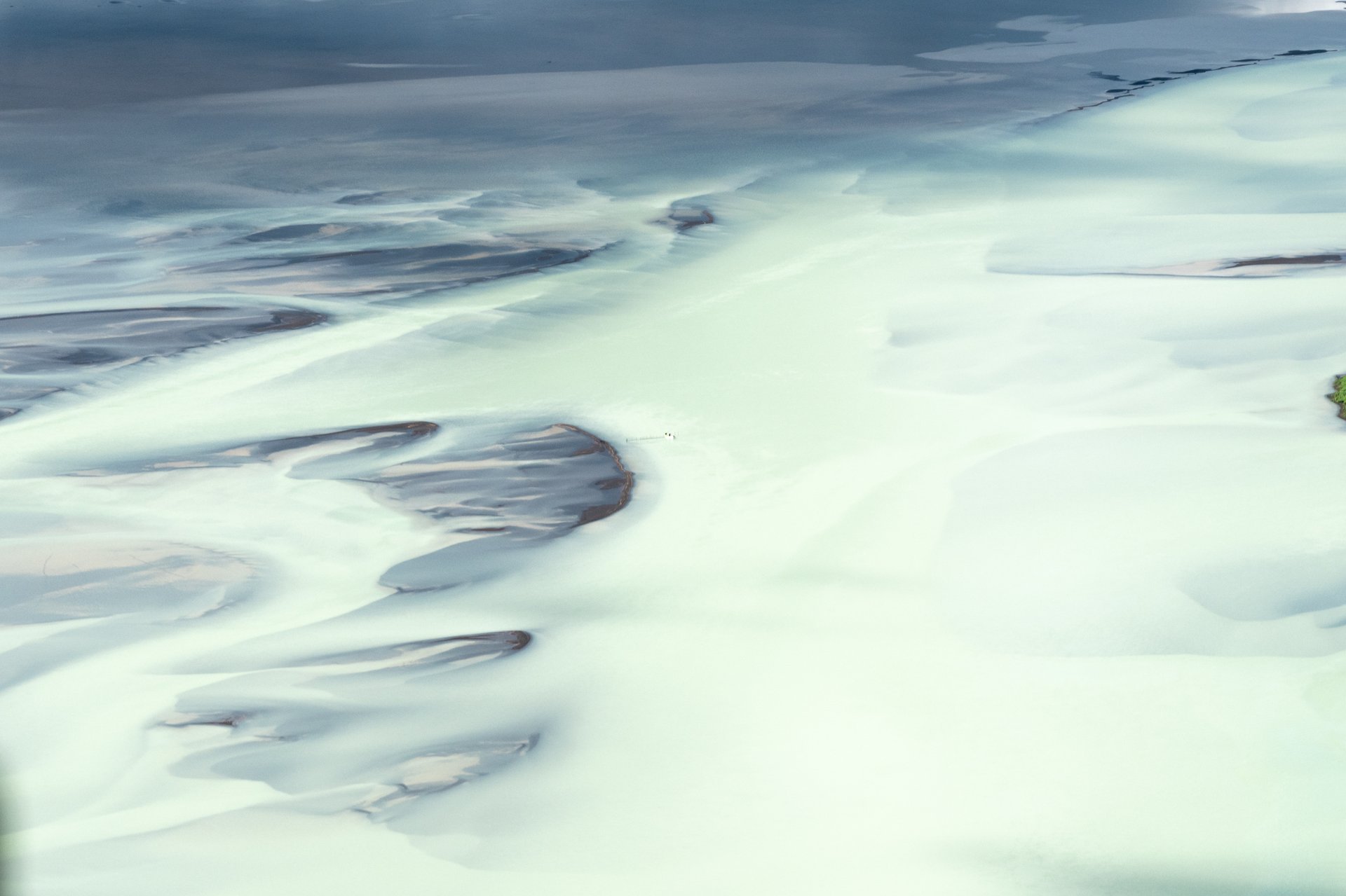 Helicopter shadow over glacier Iceland aerial tour
