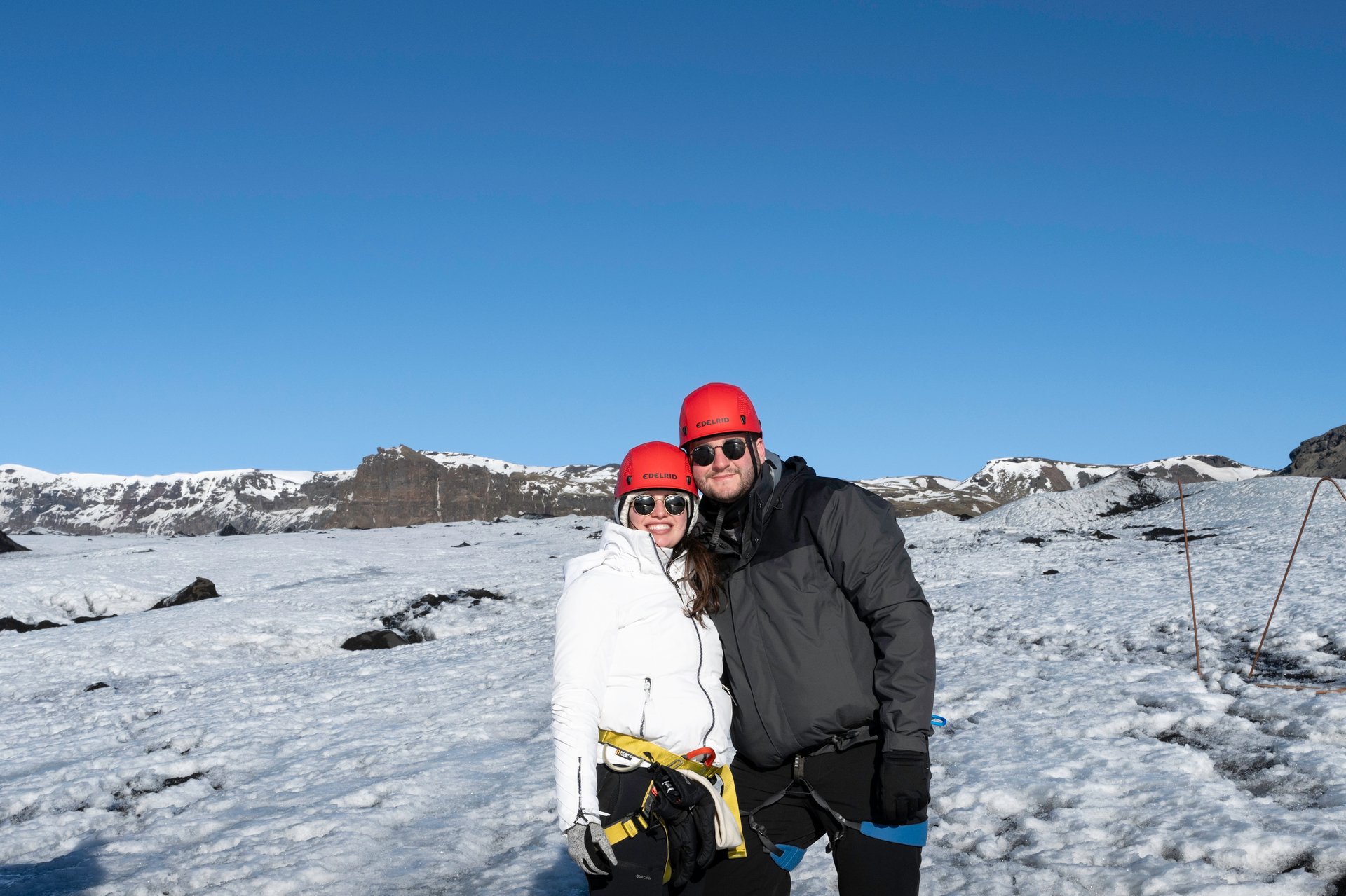 Another perspective of couple on glacier hike adventure