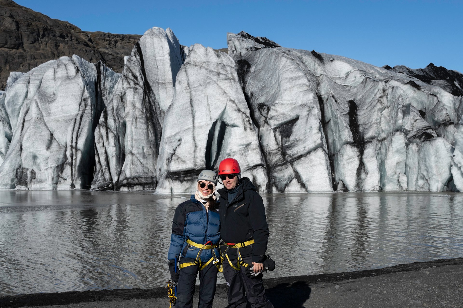 Couple exploring a glacier together on their honeymoon adventure