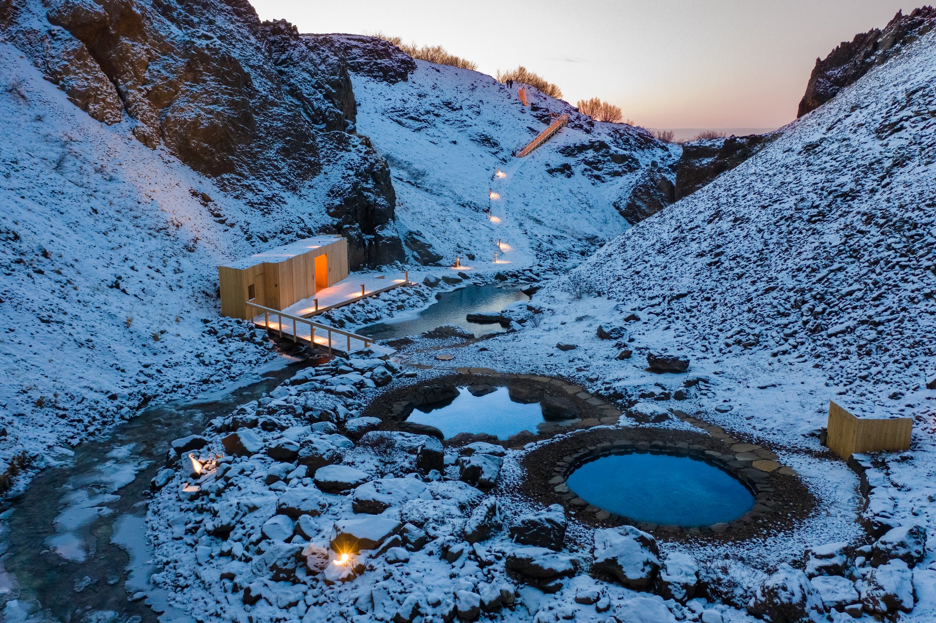 Húsafell Canyon Baths nestled in a dramatic canyon setting