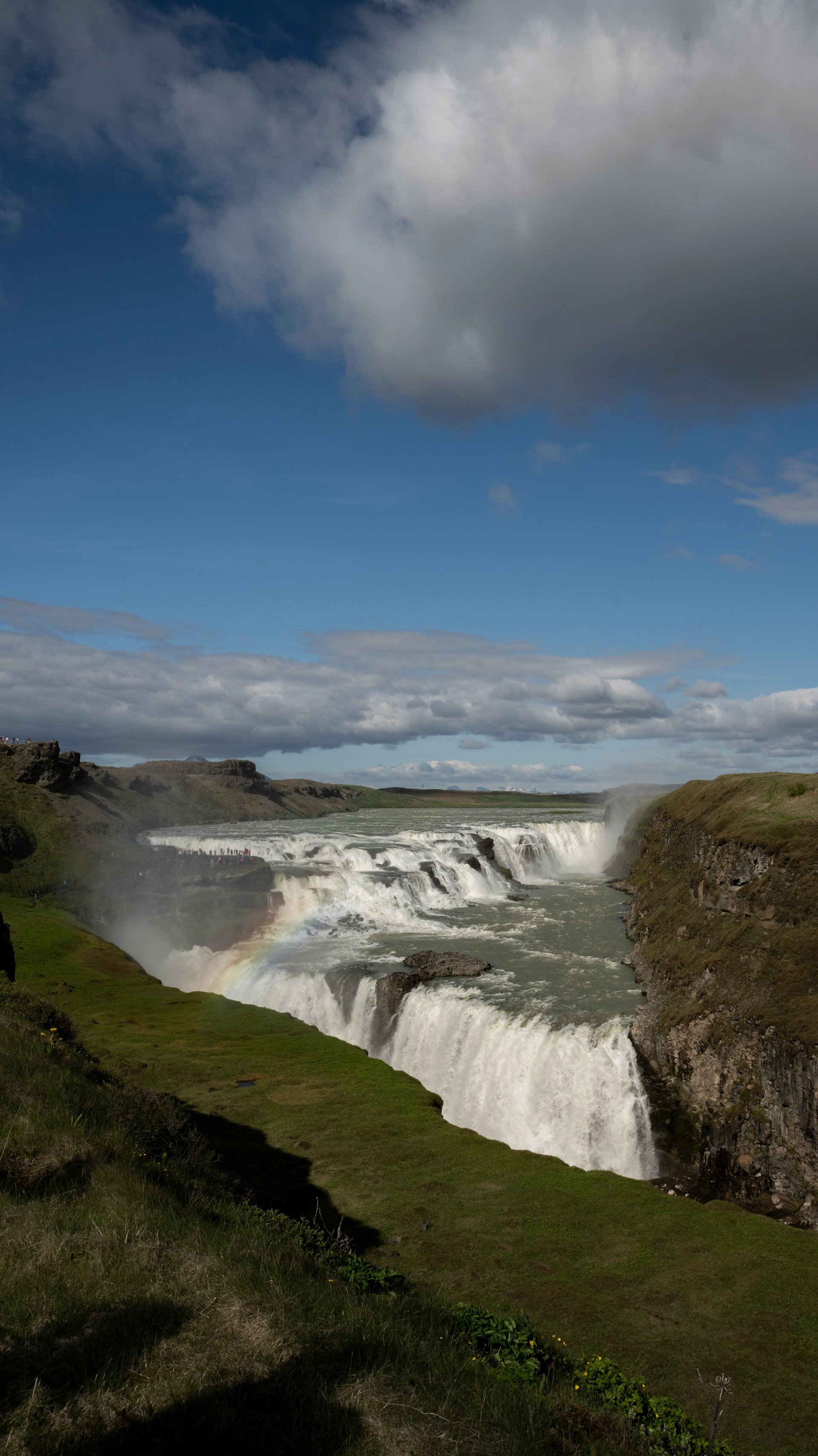 Gullfoss spray throwing a rainbow across the gorge on a sunny June afternoon, Golden Circle Iceland
