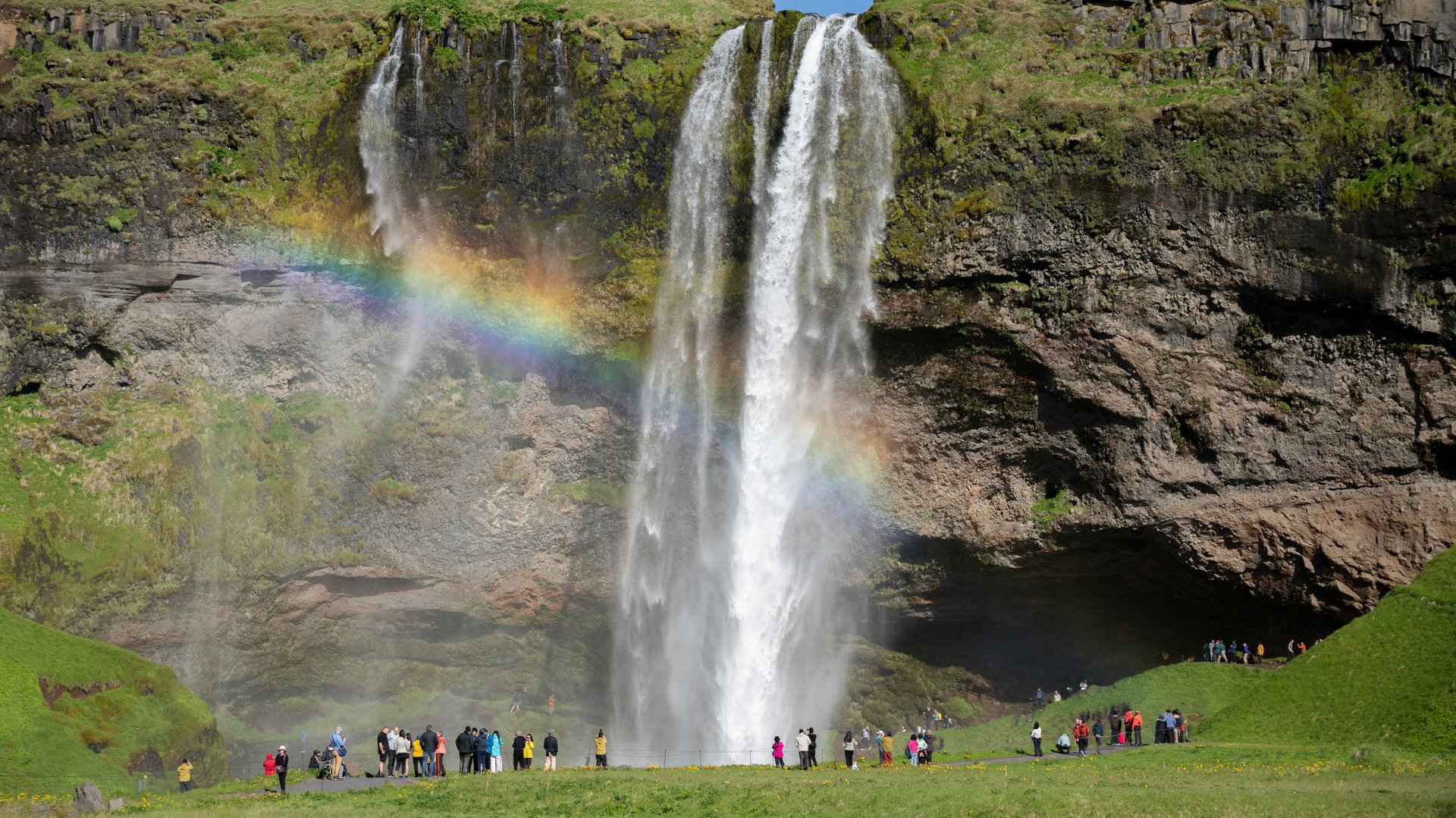 Path behind Seljalandsfoss waterfall full June flow south coast Iceland