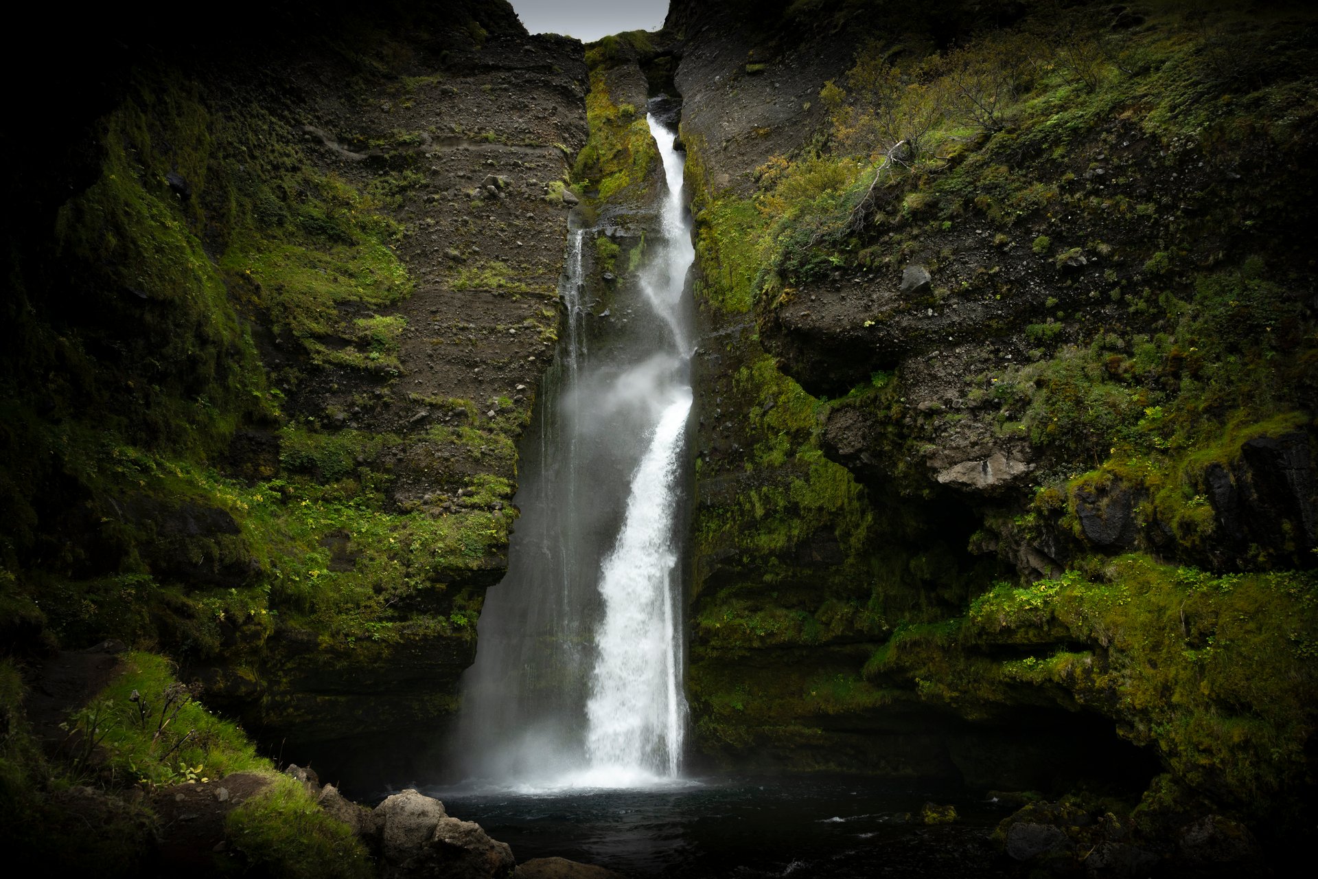 Summer landscape in Iceland with a lesser-known waterfall tucked into a green gorge