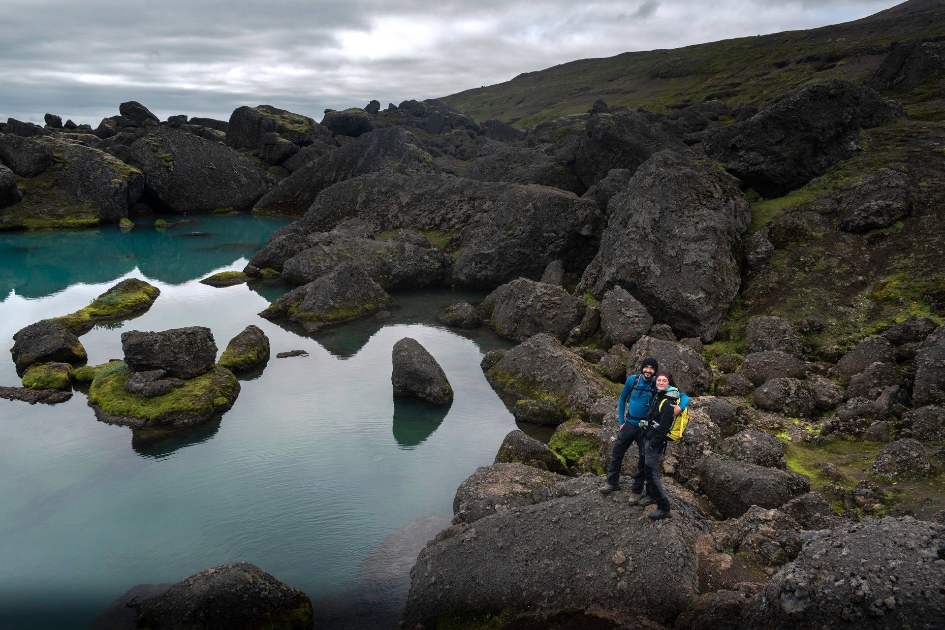 Hikers exploring dramatic Icelandic highland landscape in summer