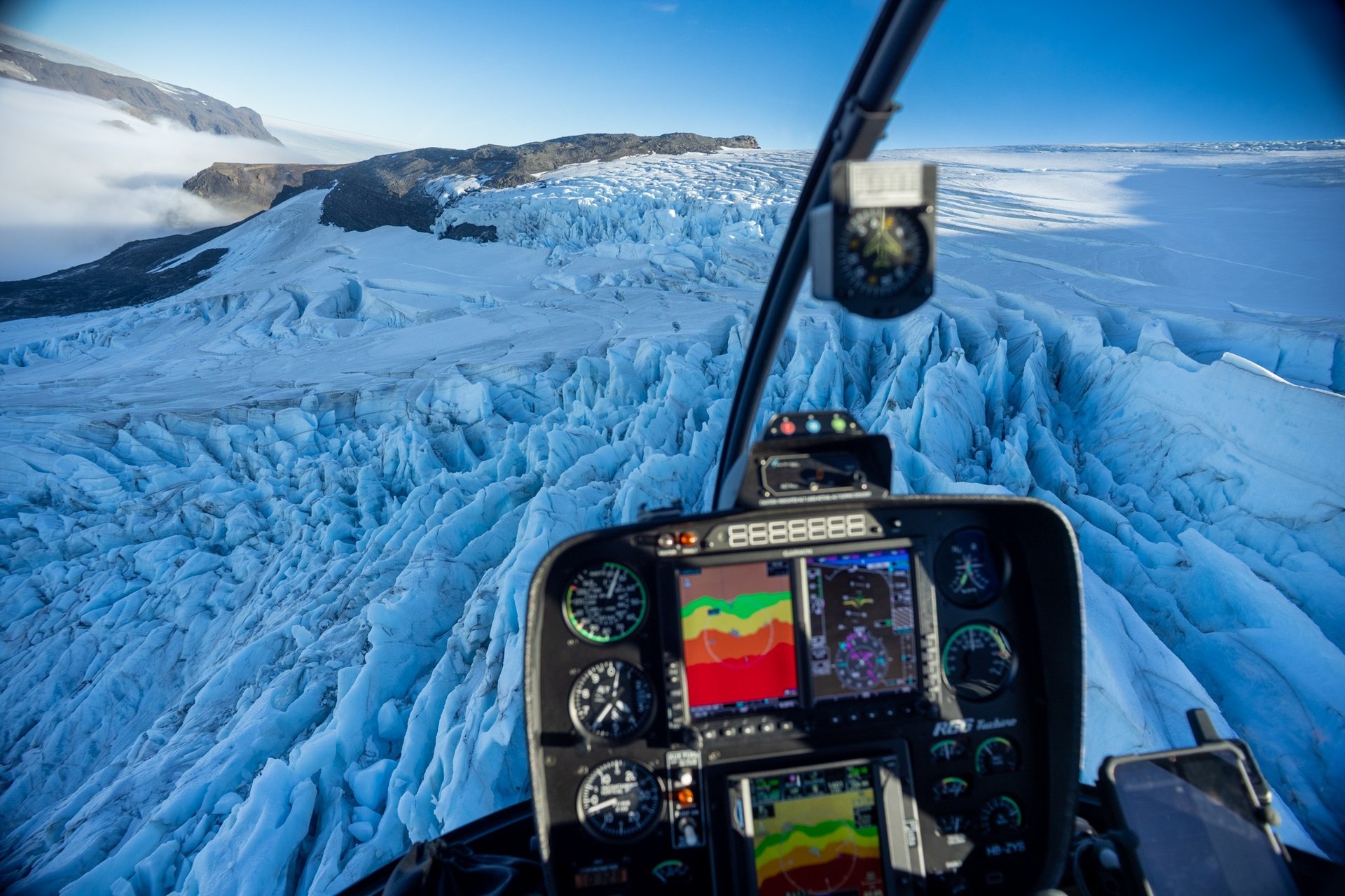 Helicopter approaching pristine glacier for landing in Iceland