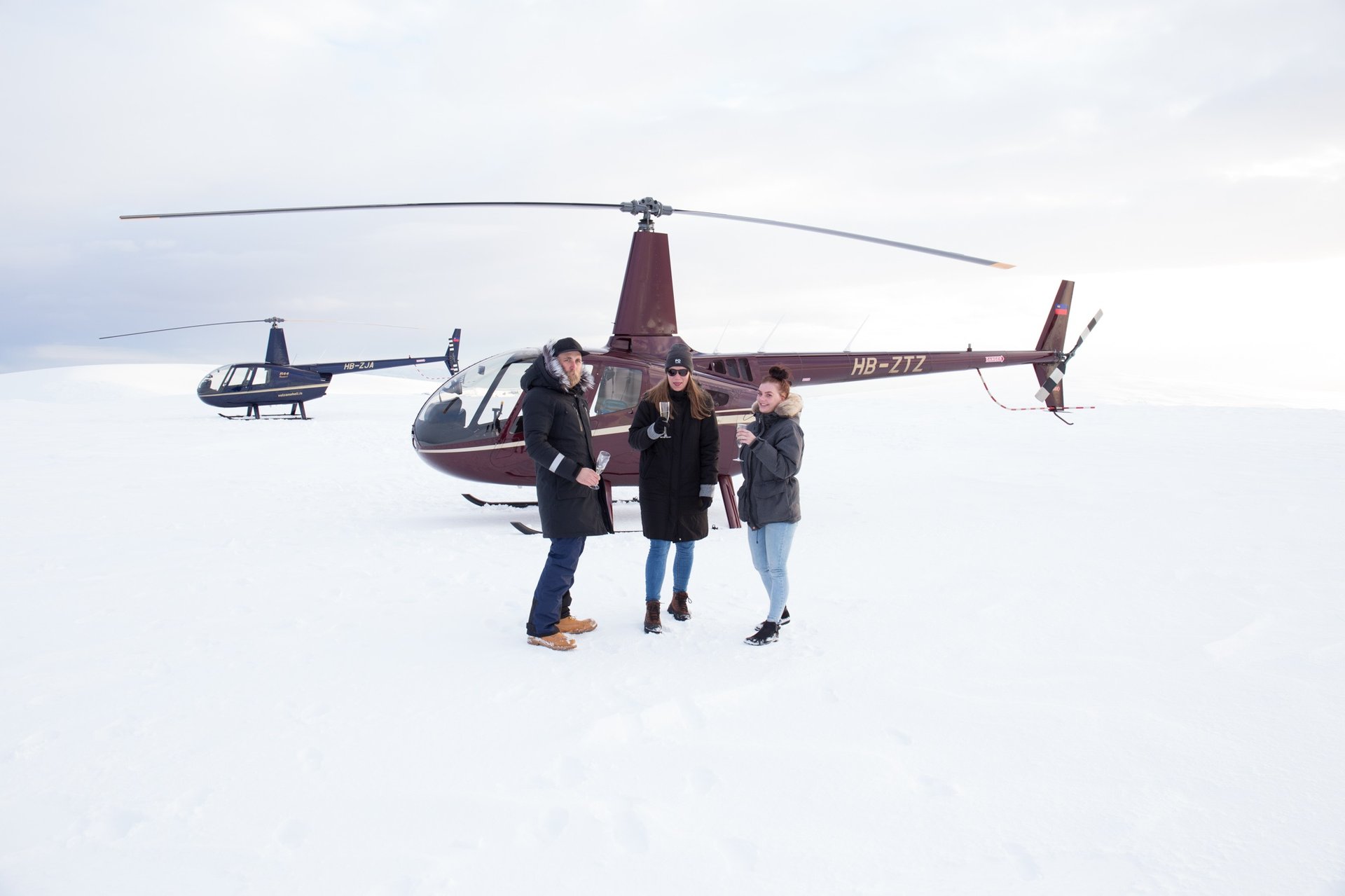 Helicopter on glacier with travelers exploring ancient ice formations