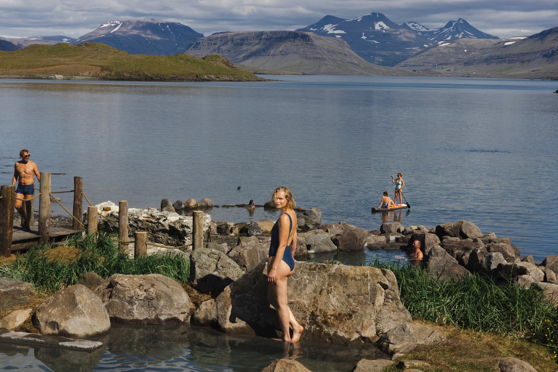 Visitors relaxing in authentic Icelandic oceanside hot springs