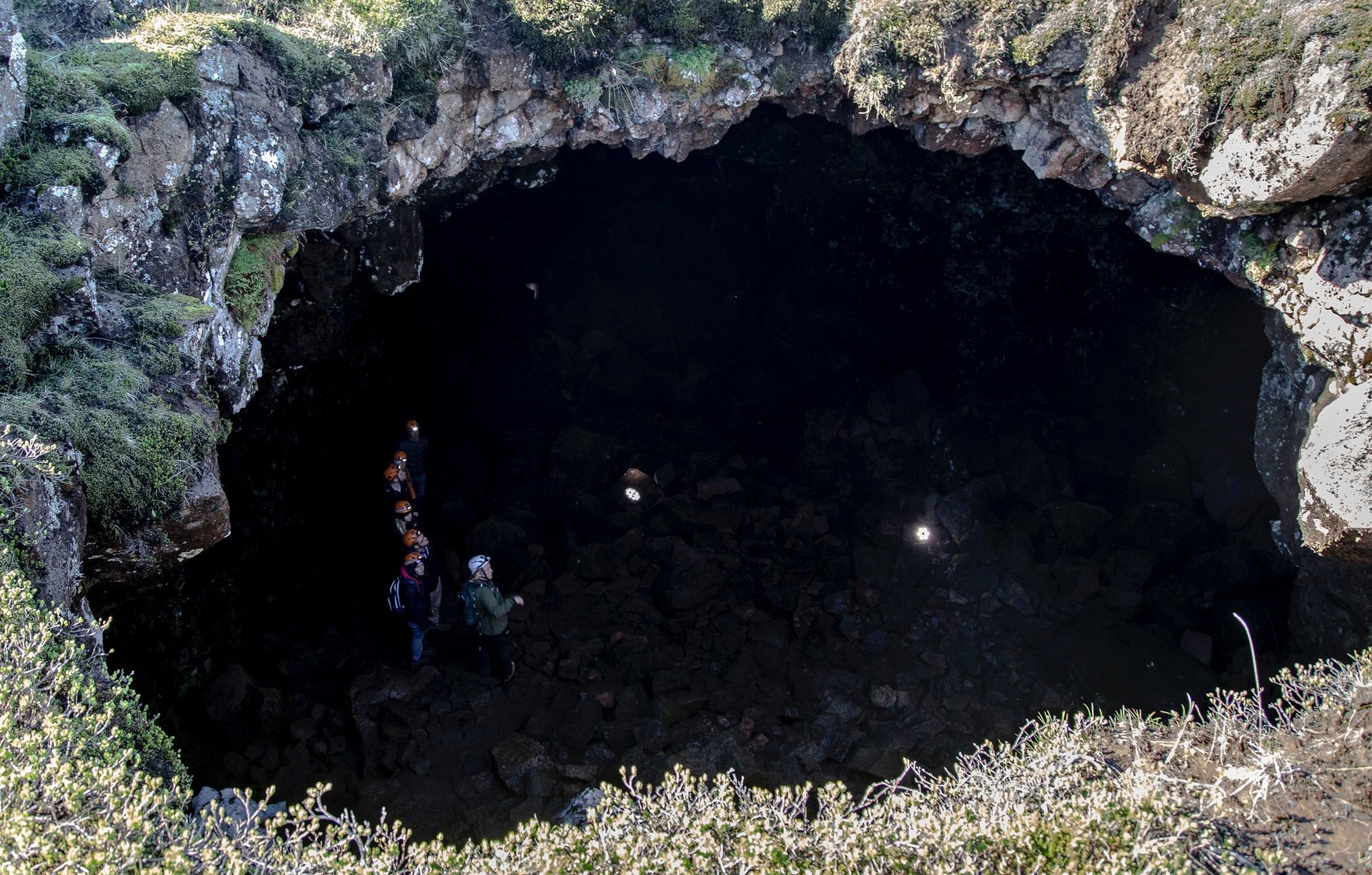 Adventure caving through challenging terrain in Raufarhólshellir