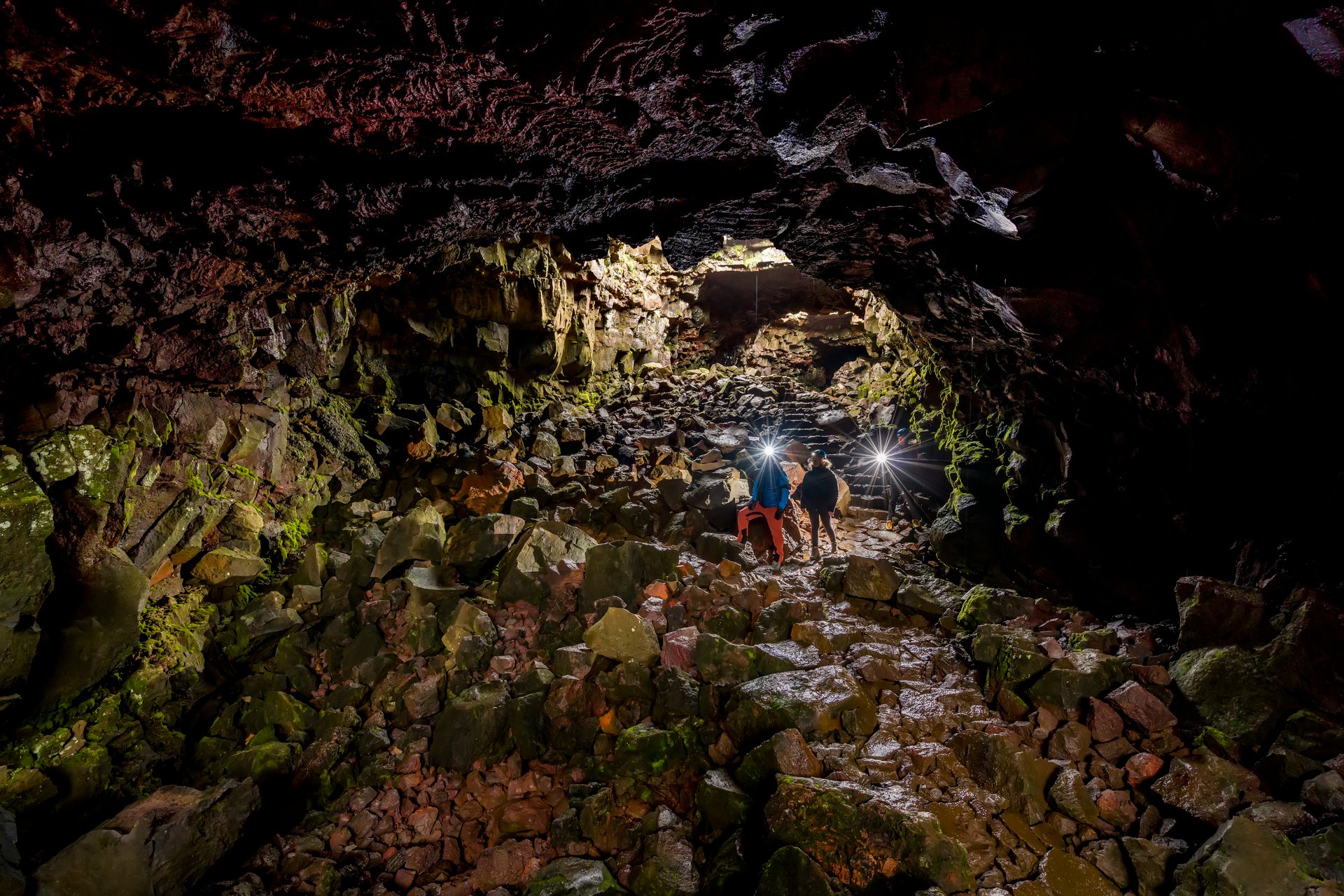 Adventure caving in Raufarhólshellir lava tunnel with hidden waterfalls