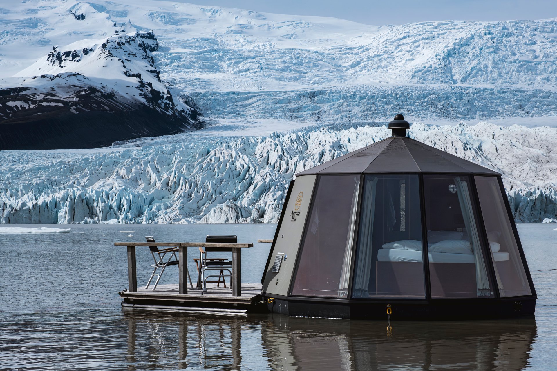 Luxury glass igloo boat floating on Fjallsárlón glacier lagoon Iceland