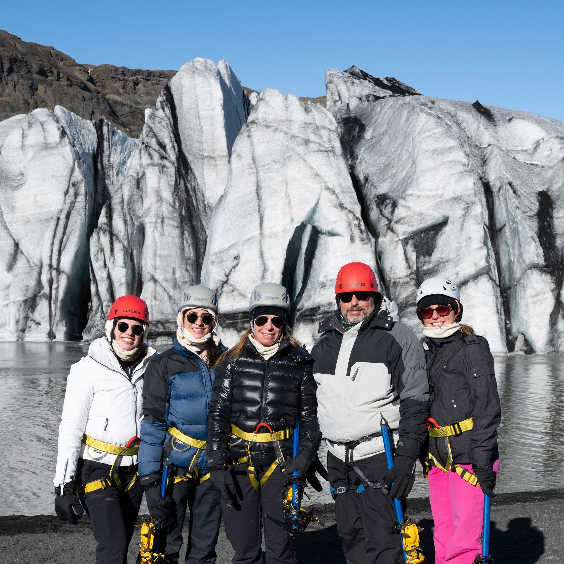 Adventure team on ancient ice exploring glacier terrain