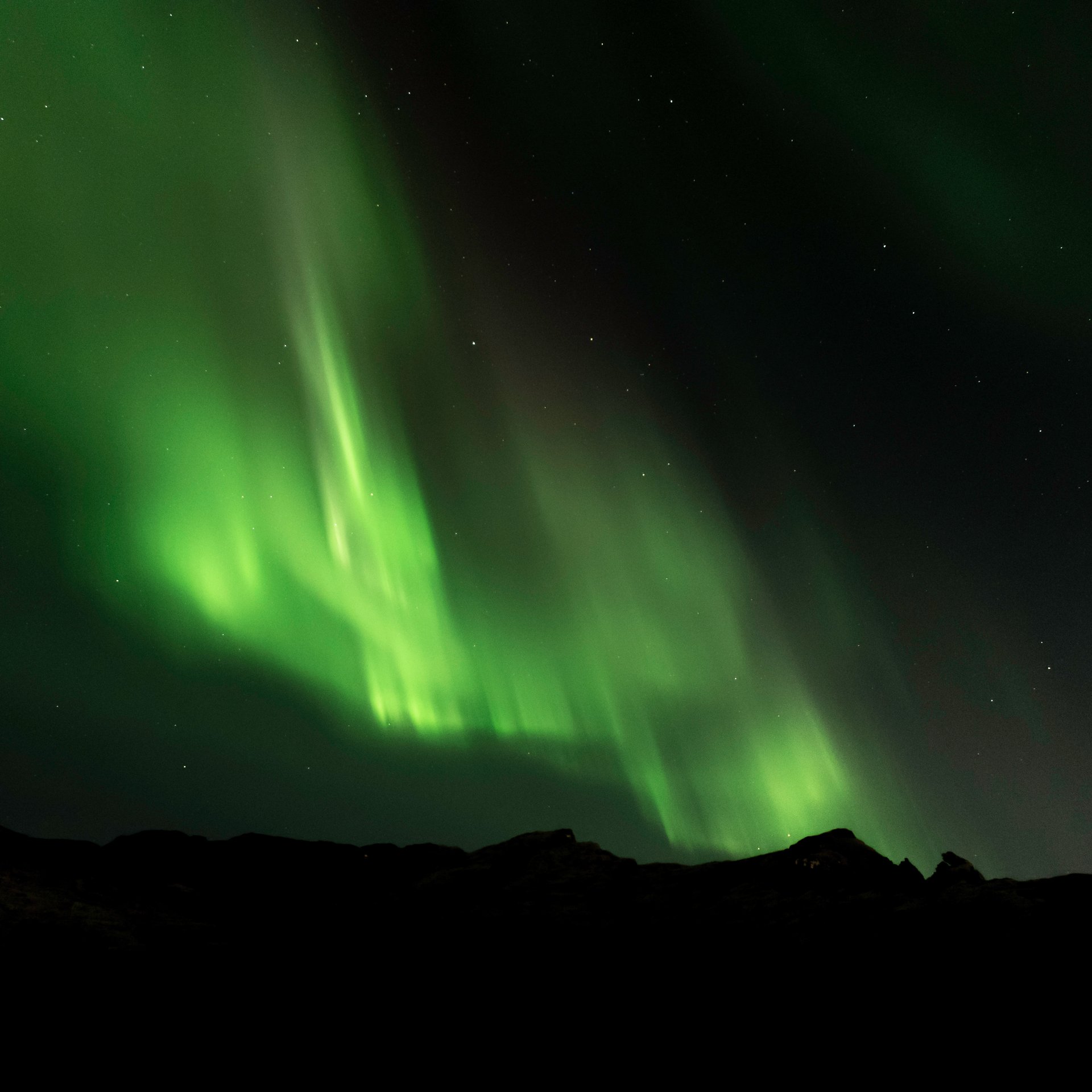 Northern Lights over snowy Iceland winter landscape