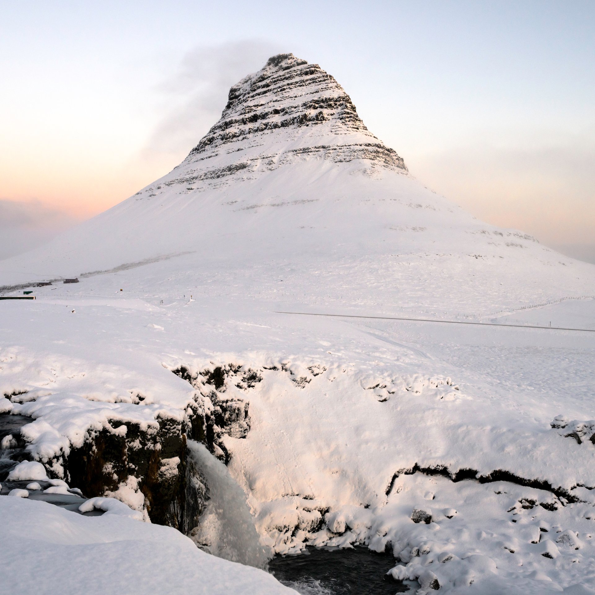 Kirkjufellsfoss waterfall with mountain reflection