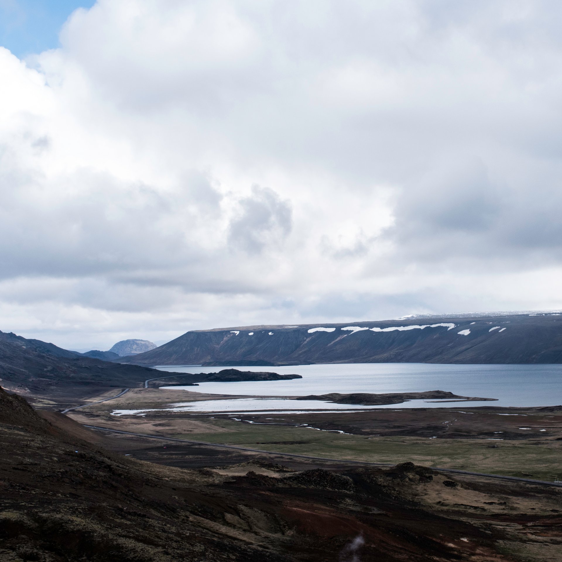 Kleifarvatn volcanic lake with dark sand shores and mountain reflections on the Reykjanes Peninsula