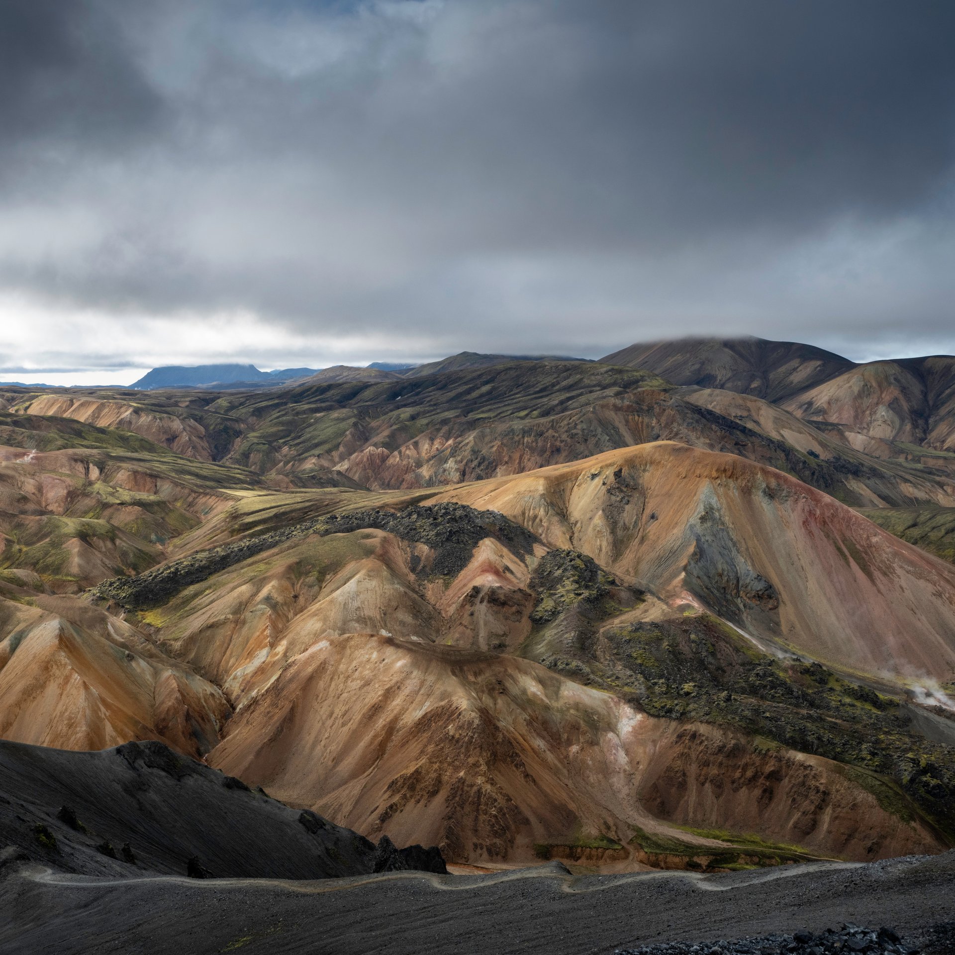 Vibrant rhyolite mountains with red, orange, and green mineral deposits in Landmannalaugar