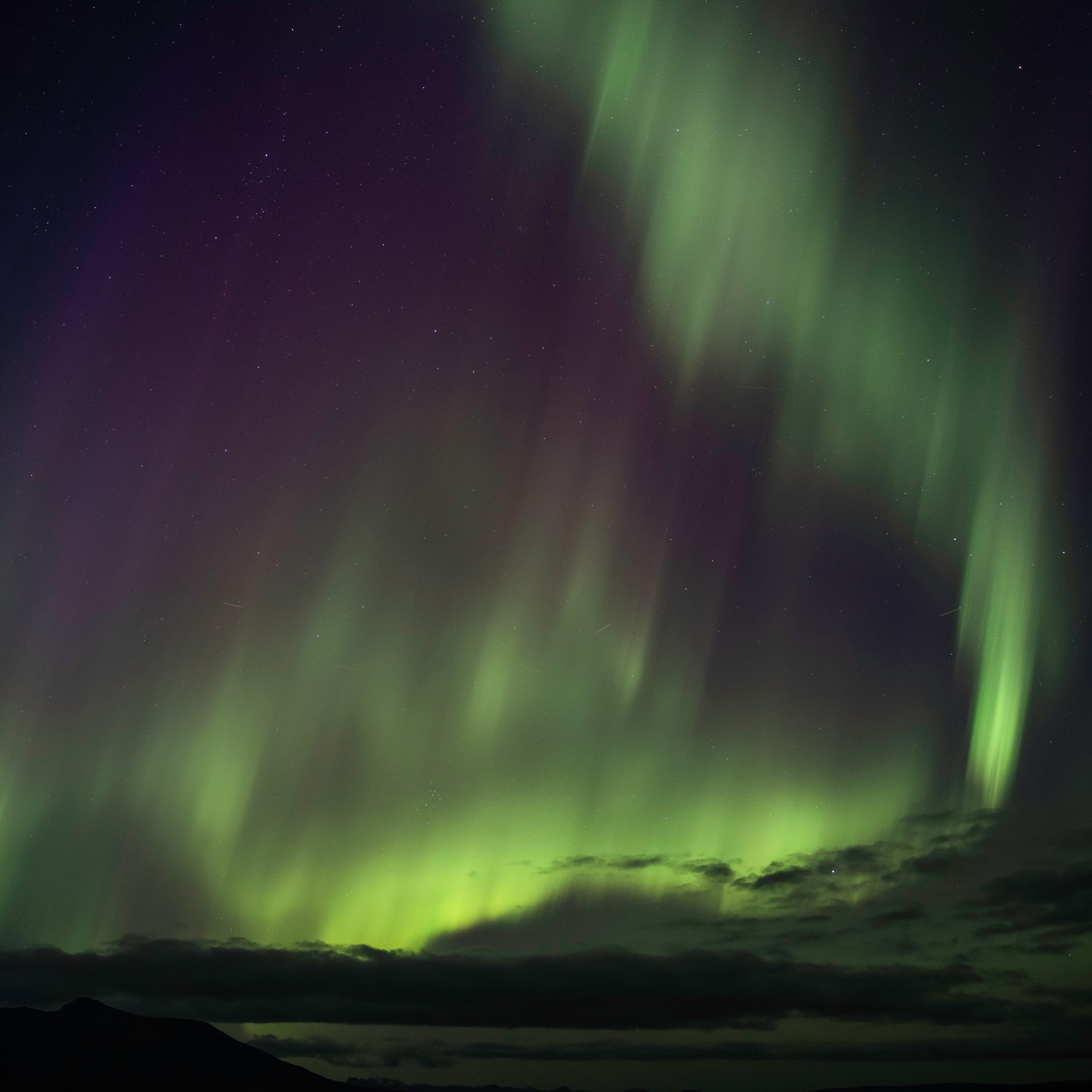 Aurora Borealis scientific explanation with guide pointing to Northern Lights formation