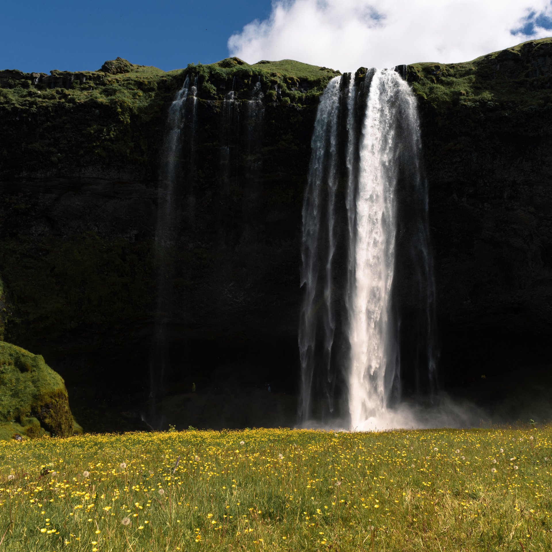 Magnificent Seljalandsfoss waterfall with path leading behind the cascading water
