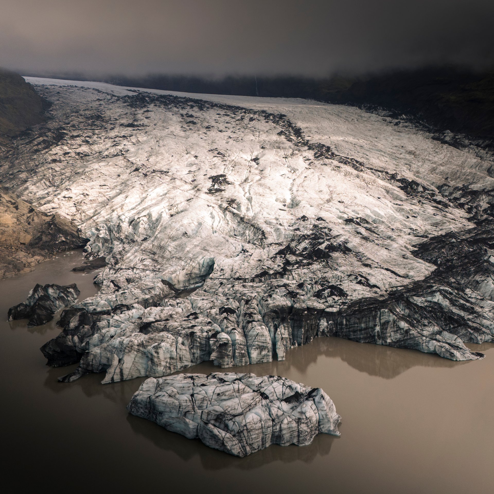 Sólheimajökull glacier with ash-covered ice formations and dramatic crevasses