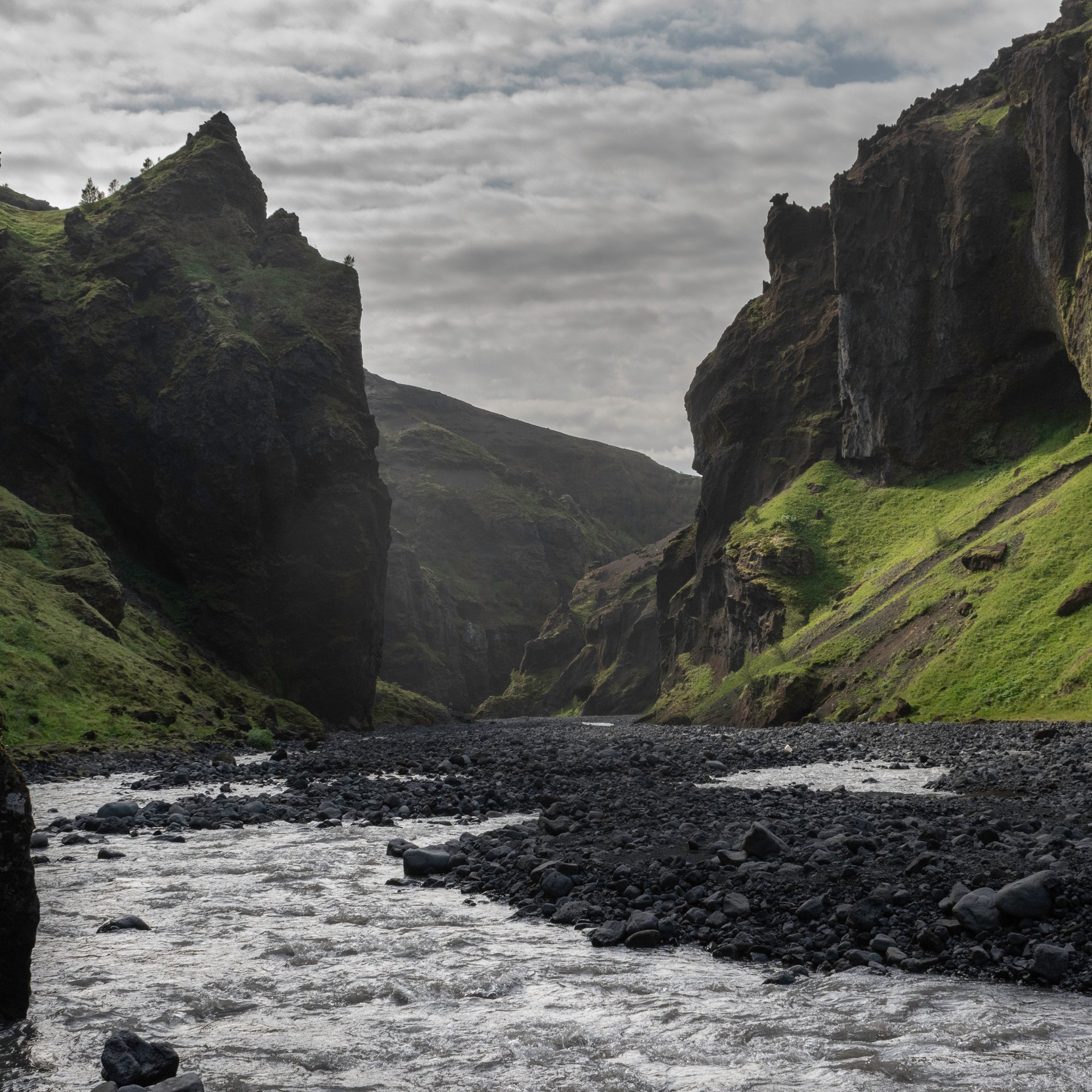 Dramatic Stakkholtsgjá canyon with towering cliffs and hidden waterfall deep in Þórsmörk