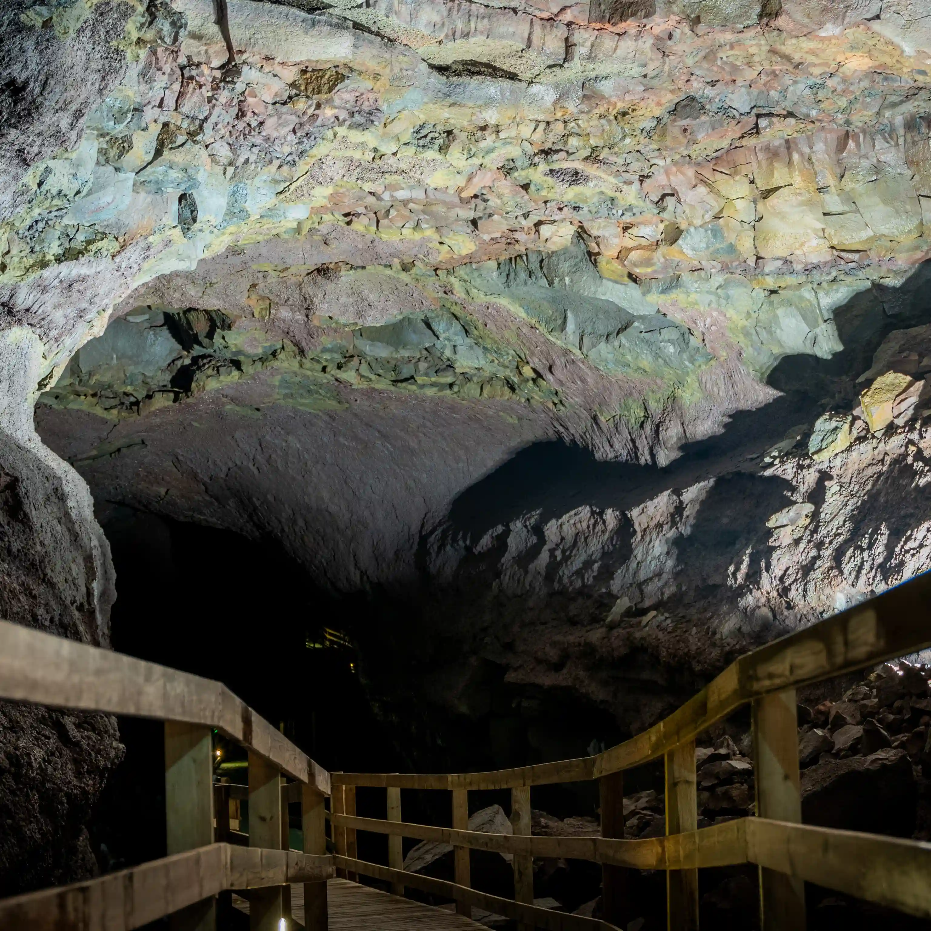Viðgelmir lava cave interior with ice formations and lava rock