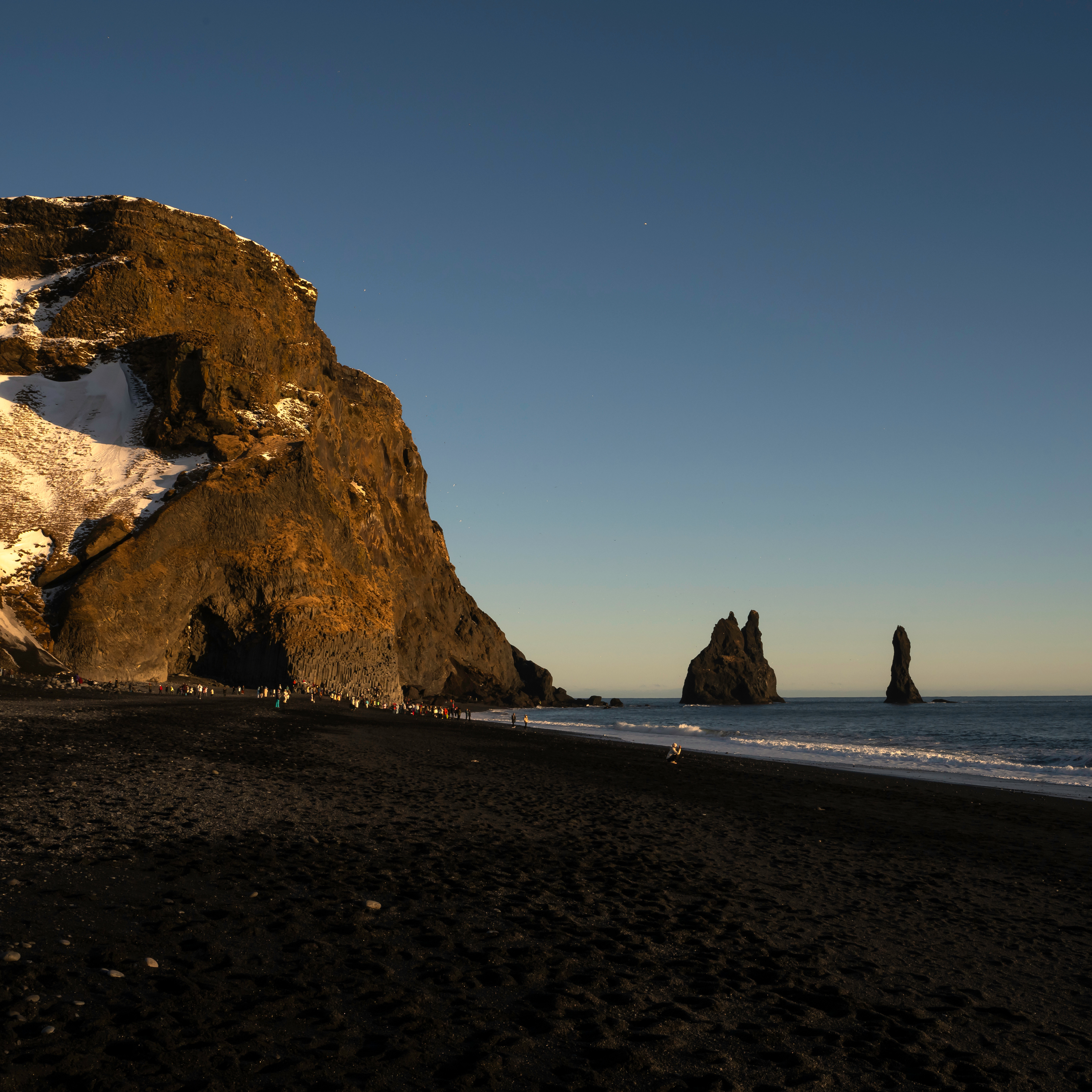 Rainbow arching over powerful Skógafoss before the glacier adventure